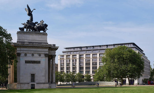 Exterior view of The Peninsula London hotel overlooking Hyde Park, showcasing its contemporary architecture